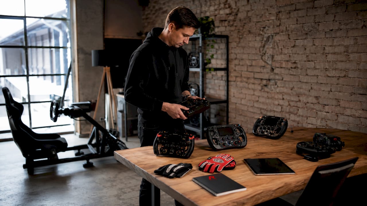 Op tafel liggen verschillende sim racing stuurwielen uitgestald.